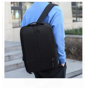 Outdoor rear view of a man wearing a black USB charging laptop backpack on city stairs