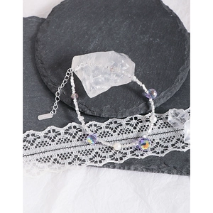 Elegant S925 silver bracelet featuring purple crystals and pearls on a stone backdrop