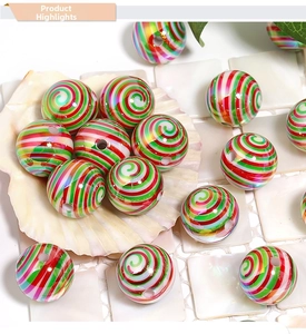Macro detail of red and green candy-striped acrylic beads for DIY Christmas jewelry crafts