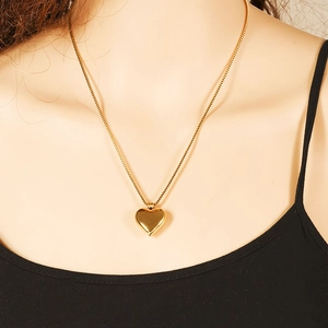Minimalist 18k gold plated hollow heart necklace for women shown on a model