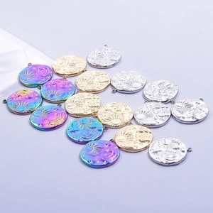 Macro shot of sun and moon engraved pendants in gold, silver and iridescent finishes