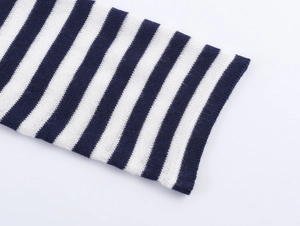 Close-up of navy and white striped knit fabric showing fine texture and sleeve detail