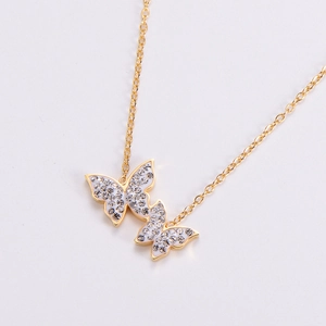 Golden butterfly necklace with sparkling zircon crystals and white enamel details