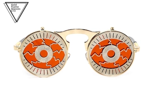 Detail of steampunk flip sunglasses with golden metal frame and orange eyeball lens texture