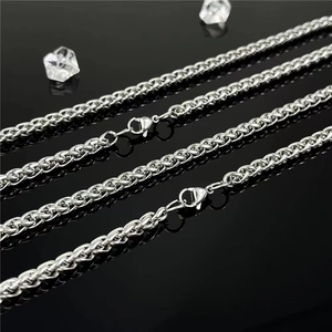 Vintage stainless steel basket weave chain bracelet with lobster clasp on reflective black surface