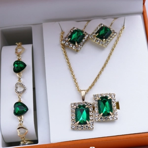 Close-up of emerald green jewelry set with necklace and earrings in a luxury gift box