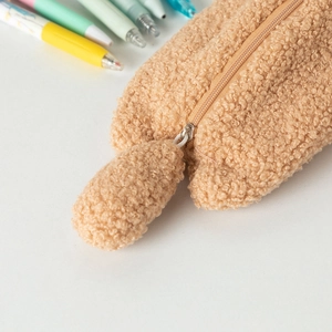 Close-up of teddy plush pencil case showing soft texture and color-matched zipper pull