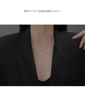 Detail view of gold-plated S925 silver necklace with sparkling zircon smile pendant