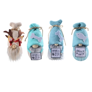 Set of four knitted pet themed Christmas gnomes with bone and fish details on white background
