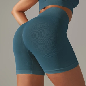 Close-up of seamless high waist yoga shorts showing peach push-up texture and knit fabric