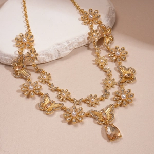 Detail of vintage double-layer necklace with crystal teardrop and pearl flower pendants