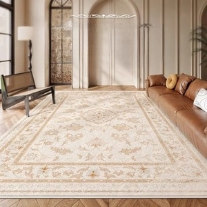 Detail of vintage French floral carpet pattern in a luxury beige living room setting