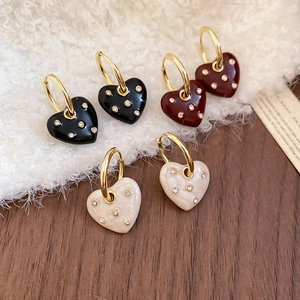 Detail shot of heart earrings in black, red and cream with sparkling rhinestones
