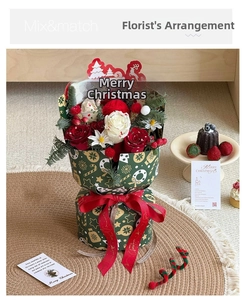 Detail of Christmas bouquet gift box with red roses, pine cones and Merry Christmas ribbon