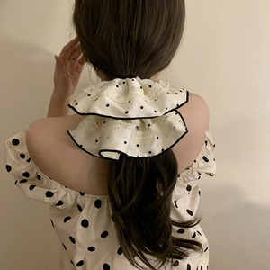 Polka dot lace scrunchie in black and white fabric, vintage style shown on model