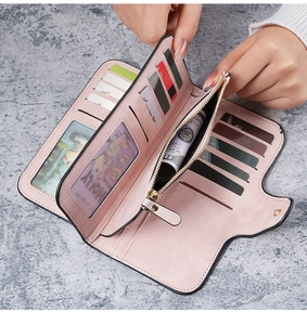 Detailed view of open pink long leather wallet showing multiple card slots and coin pocket