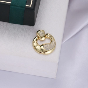 Detailed view of micro-paved crystal heart pendant in gold on a textured gift box