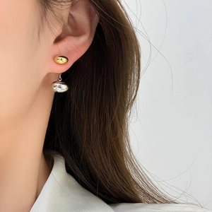 Minimalist two-tone oval bean stud earrings with polished gold and silver finish