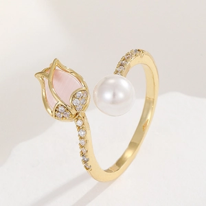 Detail of 18K gold ring with pink tulip cat-eye stone, pearl and pavé zircon accents
