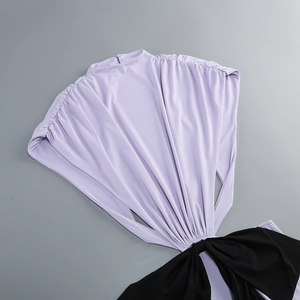 Detail of lavender purple pleated fabric with a black waist knot design on a dress
