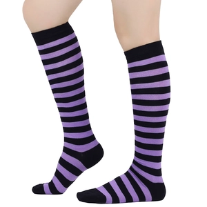 Detail shot of purple and black horizontal striped knee-high socks worn by a model