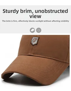 Detail of a brown cotton baseball cap showing the shield badge and stiff curved brim
