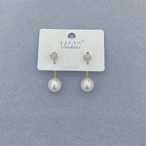 Detailed view of S925 silver needle pearl drop earrings with sparkling rhinestone studs