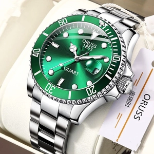 Macro side view of green dial quartz watch with steel strap in a white leather gift box