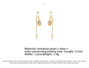 Detail of tulip earrings with gold metal, pink stones and hanging white pearls