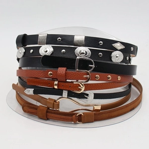 Detail view of retro faux leather thin belts with metal rivets and vintage floral buckles