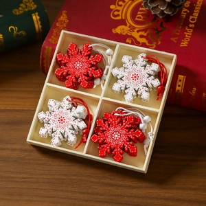 Macro detail of red and white wooden snowflake ornaments in a four-grid storage box