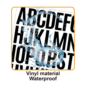 Macro shot showing splashing water on waterproof vinyl alphabet stickers for labeling
