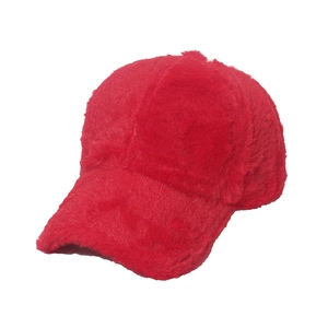 Detailed close-up of fluffy red faux fur texture on a warm winter baseball cap