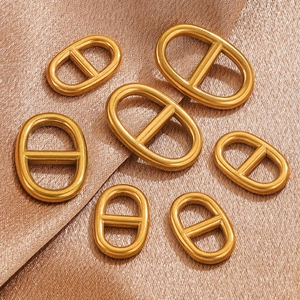 Golden oval stainless steel pig nose buckles in various sizes on champagne satin silk