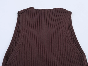 Detailed macro view of dark brown ruffle knit top neckline and shoulder texture