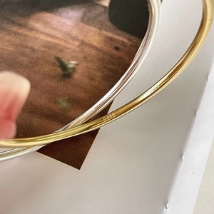 Macro detail of the S925 sterling silver hallmark engraved inside the geometric bangle