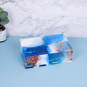 Macro view of blue and white marble resin storage box with gold leaf foil accents