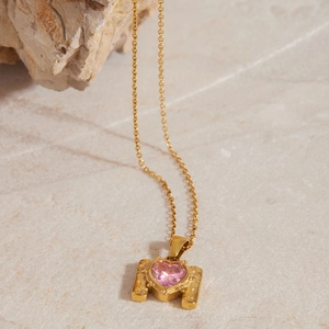 Minimalist gold stainless steel necklace featuring a heart-shaped pink zircon pendant