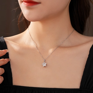 Gros plan d'un collier pendentif étoile en argent avec zircone sur un cou de femme