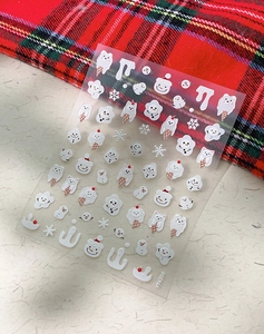 Close-up of embossed 5D nail stickers with winter snowman and snowflake patterns