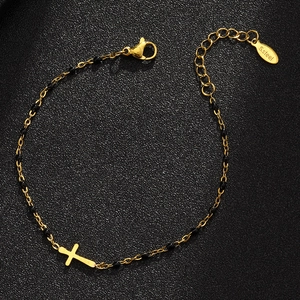 Detail of gold beaded cross bracelet with black beads and S.Steel engraving tag