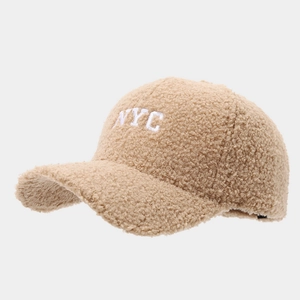Detailed view of white NYC embroidery on khaki fleece baseball cap for autumn