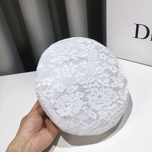 Close-up of white lace beret featuring intricate floral hollow patterns and breathable mesh