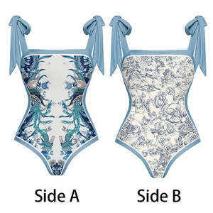 Detail of reversible one-piece swimsuit showing Side A peacock and Side B floral prints