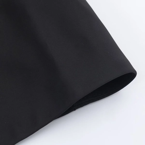 Detail view of black fabric texture and hem stitching on a shirt midi dress