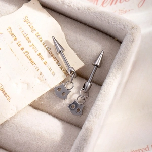 F136 titanium cat devil stud earrings with silver spike charms in a jewelry box