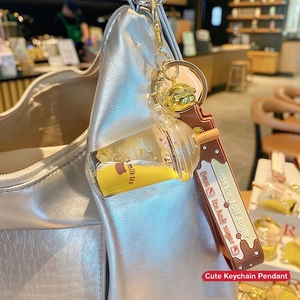 Bubble tea bear floating bottle keychain with liquid and brown silicone strap on bag