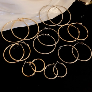 Detailed view of polished gold geometric hoop earrings in various sizes for women