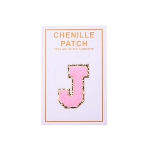 Detail of pink chenille letter J patch with gold glitter edge and peel and stick adhesive