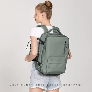 Practical view of the multifunctional grey-green travel backpack worn by a model